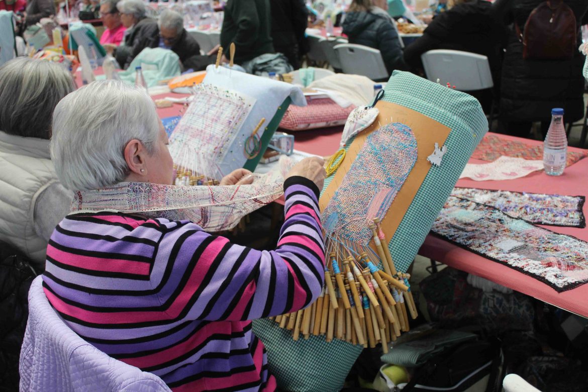 Dos encajeras con su labor de bolillos en la plaza de toros de Arroyo. ENA